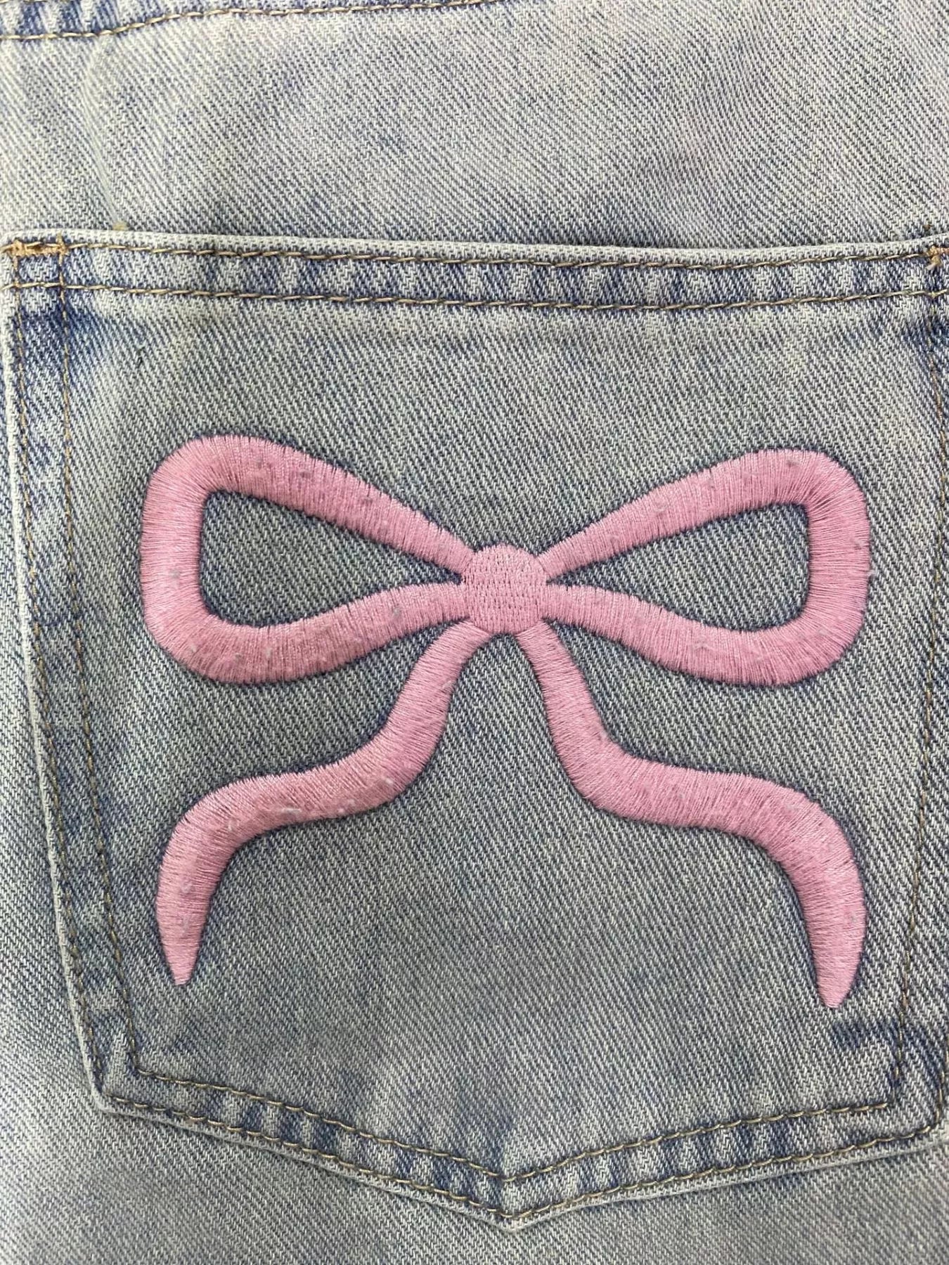 A close up view of the design on the back pocket Washed Wide Leg Jeans