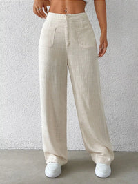 Beige linen pants worn by a person against a plain background