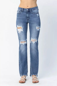 Distressed blue jeans on a white background
