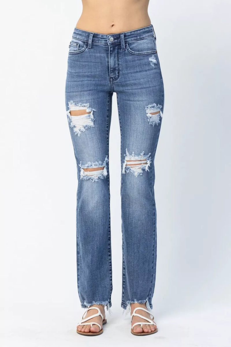 Distressed blue jeans on a white background