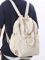 Beige backpack worn by a person on a white background