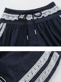 Navy blue fabric with white lace trim on a white background