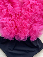 Close-up of a bright pink floral arrangement on a black background