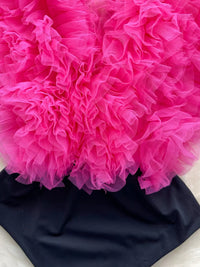 Close-up of a bright pink floral arrangement on a black background