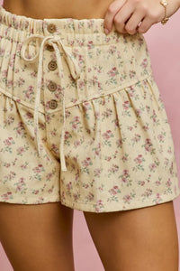 Floral shorts with a drawstring on a pink background