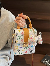 Person holding a colorful handbag with a distinctive design