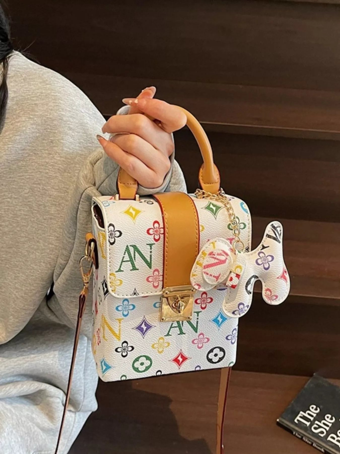 Person holding a colorful handbag with a distinctive design