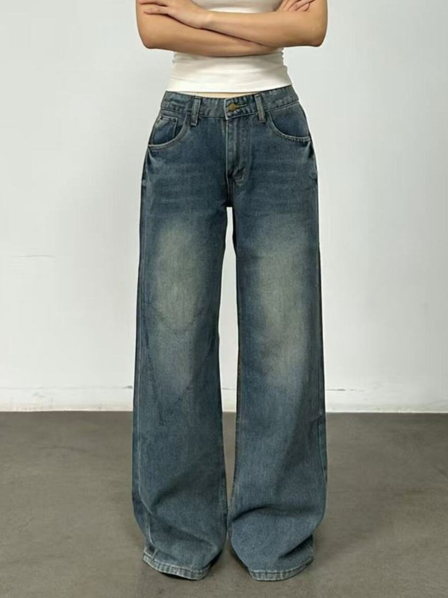 Person wearing wide-leg jeans against a plain background