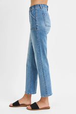 Light blue jeans worn by a person on a white background