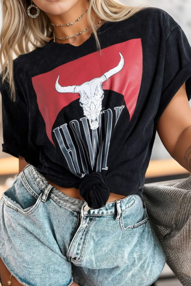 Person wearing a black t-shirt with a graphic design of a bull skull and the word 'VW'.