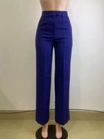 Blue pants on a mannequin against a plain background