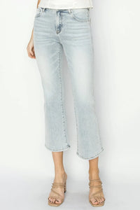 Light blue jeans worn by a person on a white background