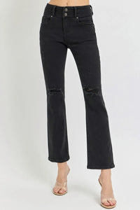 Black distressed jeans on a white background
