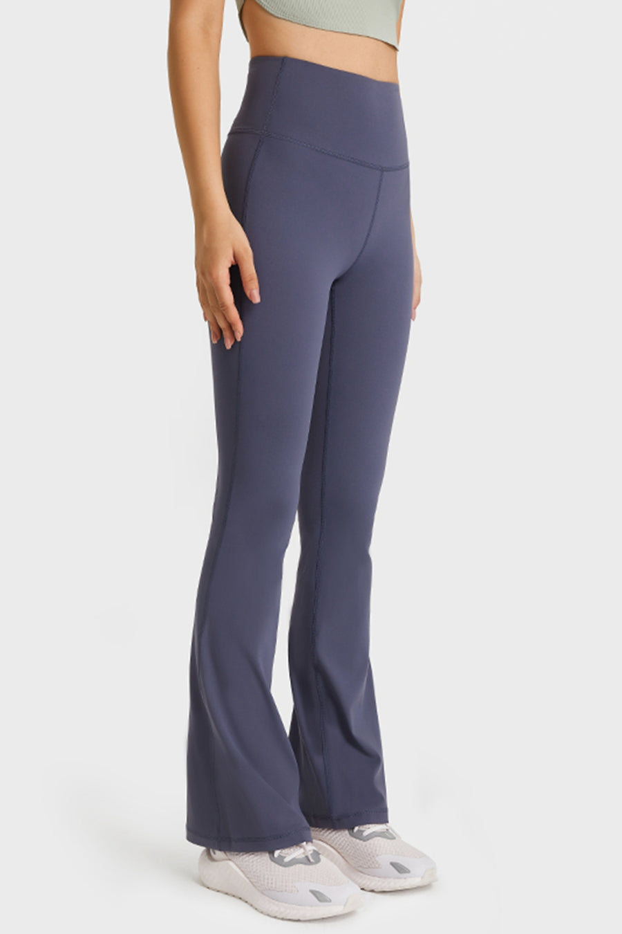 Person wearing high-waisted flared pants on a white background