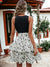 View of the back of Two Tone Tiered Ruffle Belted Floral Flared Dress