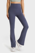 Person wearing purple leggings on a white background