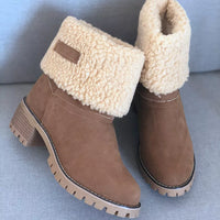 Brown ankle boots with beige fur lining on a gray surface