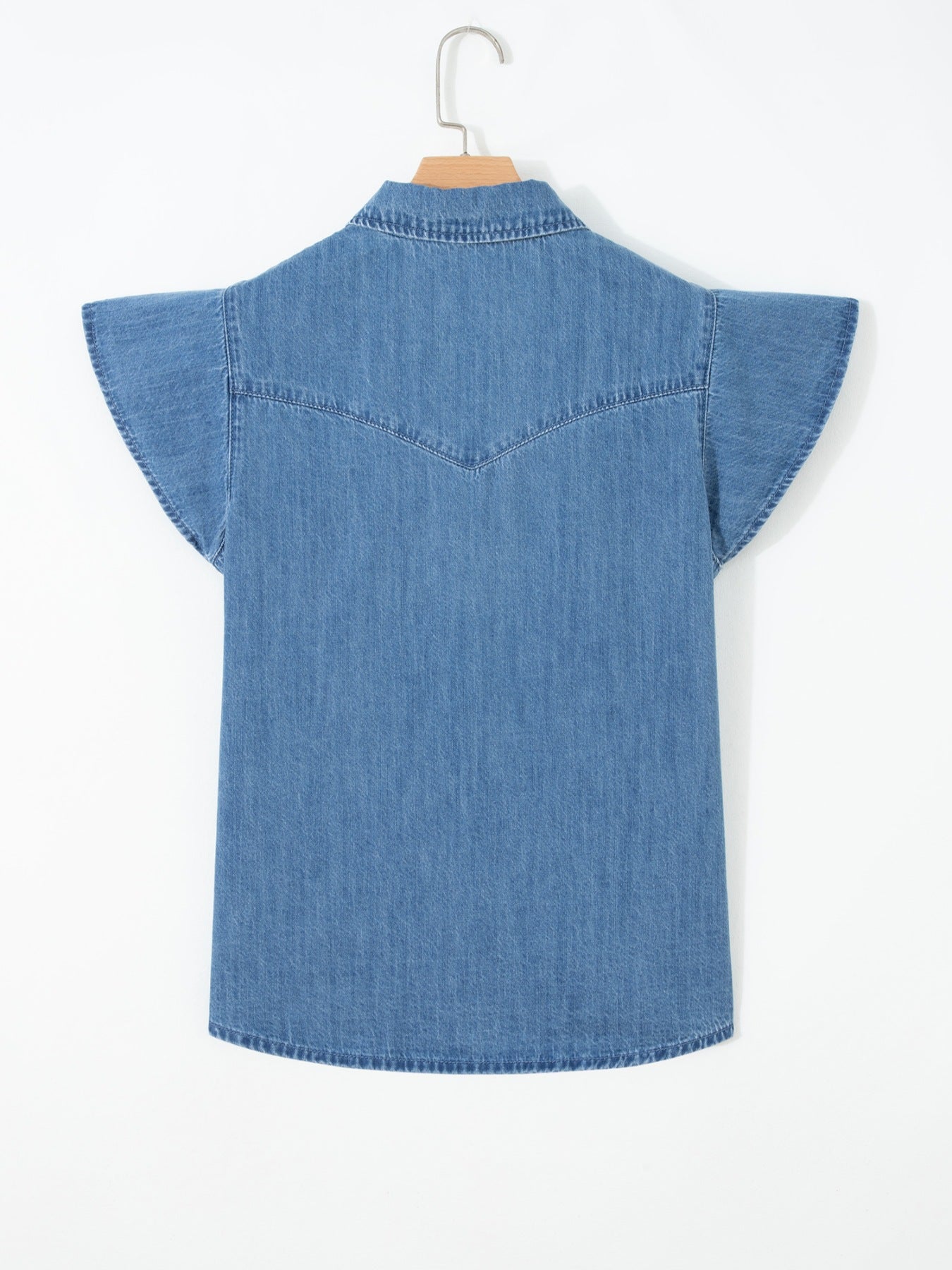 Blue denim shirt on a hanger against a white background