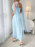 Light blue dress with sheer sleeves in a room setting