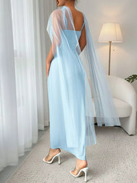 Light blue dress with sheer sleeves in a room setting