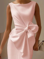 Pink dress with a large bow detail on a neutral background