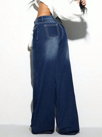 Blue wide-leg jeans worn by a person on a white background
