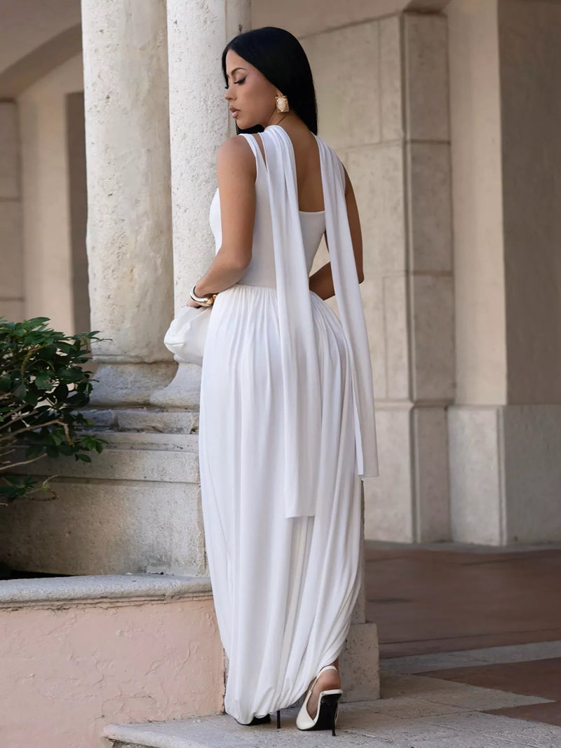 Woman in a white dress standing in front of classical architecture