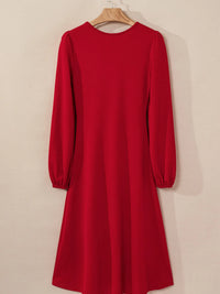 Red dress with long sleeves on a beige background