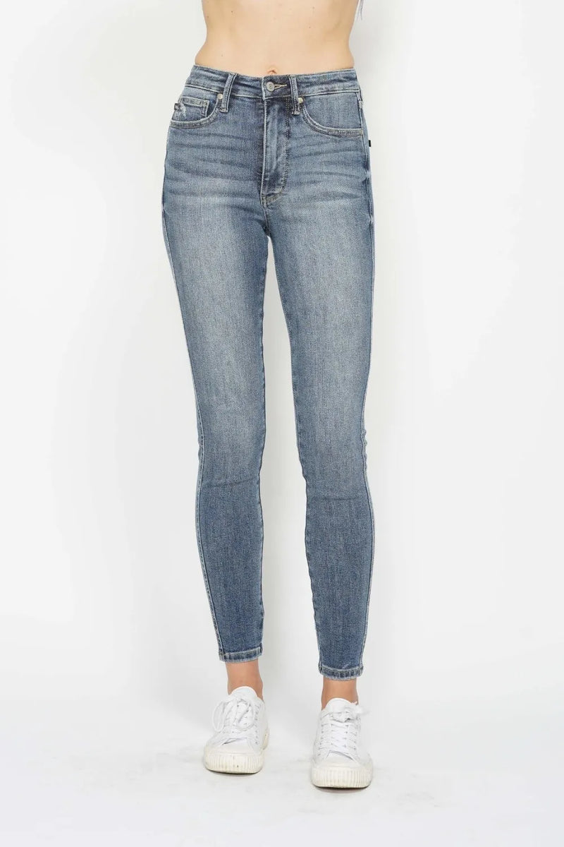 Blue jeans worn by a person on a white background