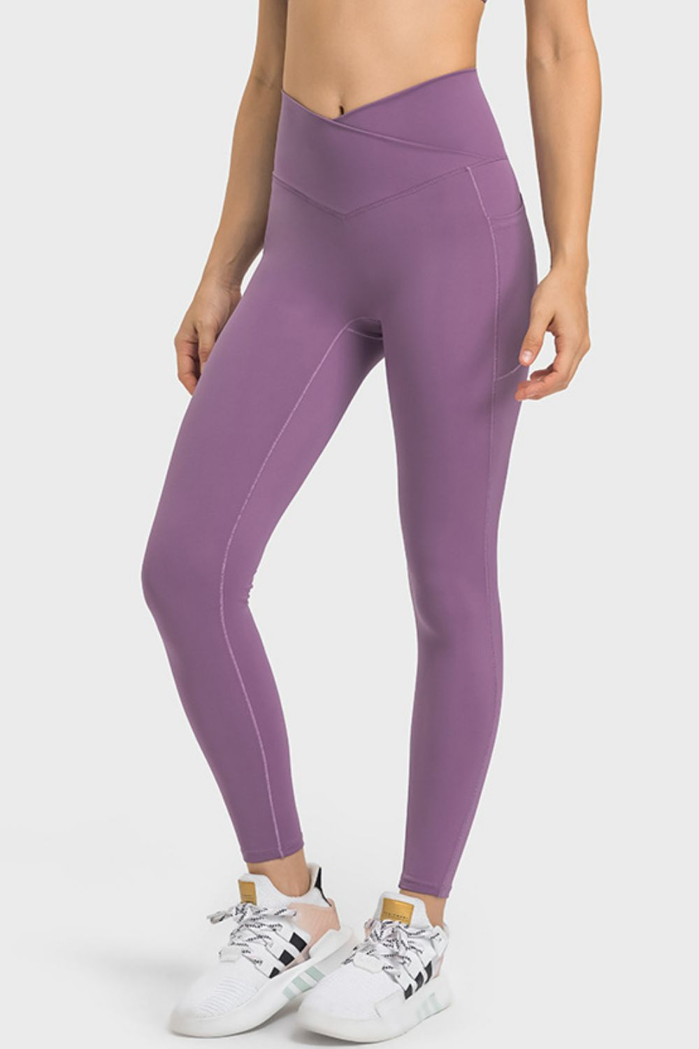 Purple leggings worn by a person on a white background