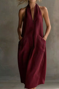 Woman wearing a burgundy dress against a neutral background