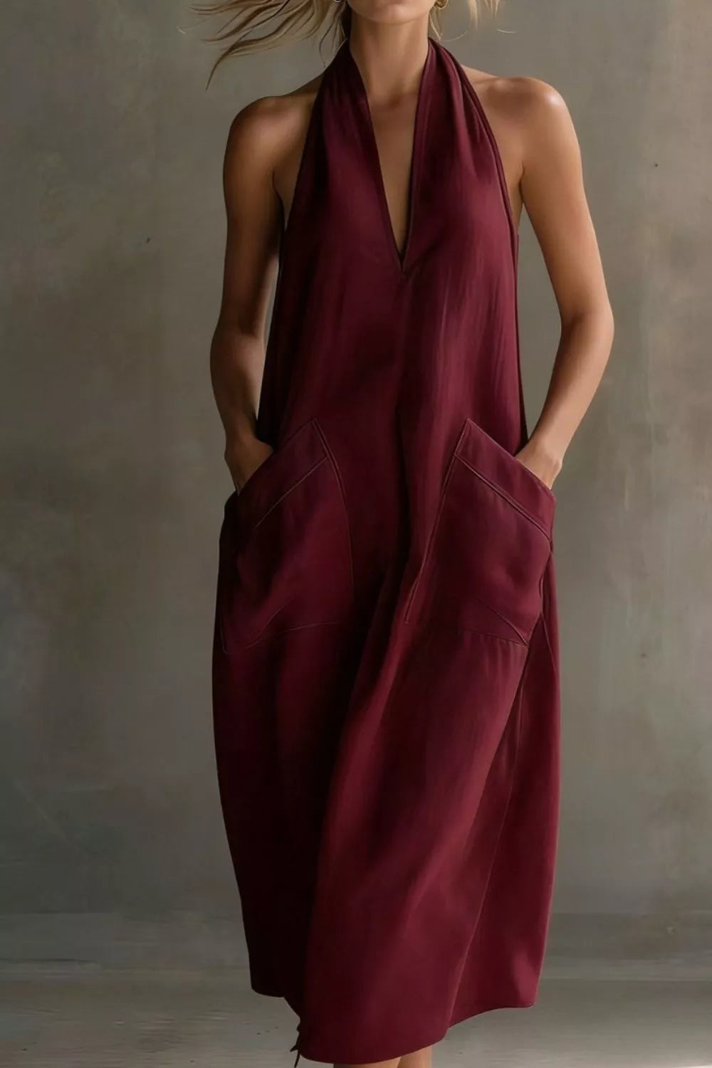 Woman wearing a burgundy dress against a neutral background