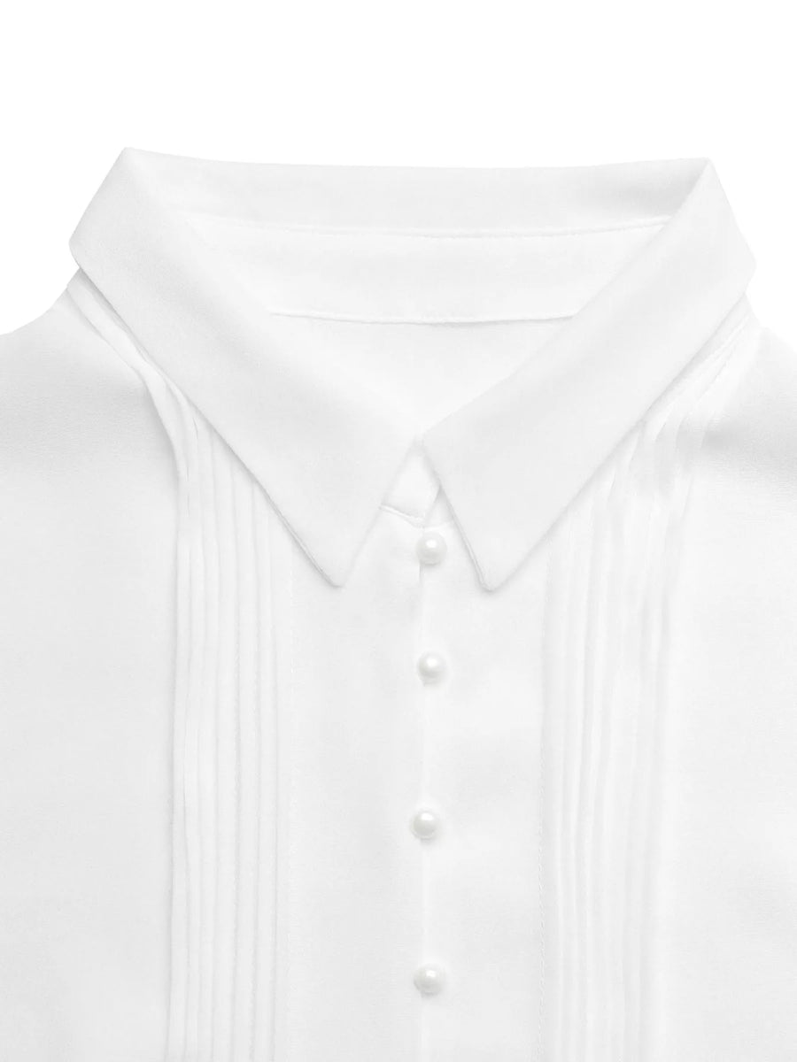 Close-up of a white shirt with a collar and buttons on a light gray background
