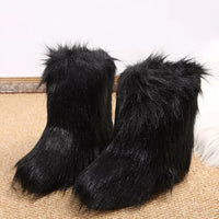 Pair of black furry slippers on a carpeted floor.