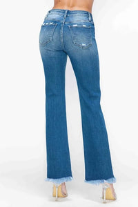 Blue jeans worn by a person on a white background