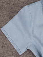 Light blue denim fabric on a brown textured surface
