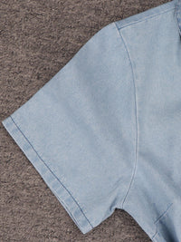 Light blue denim fabric on a brown textured surface