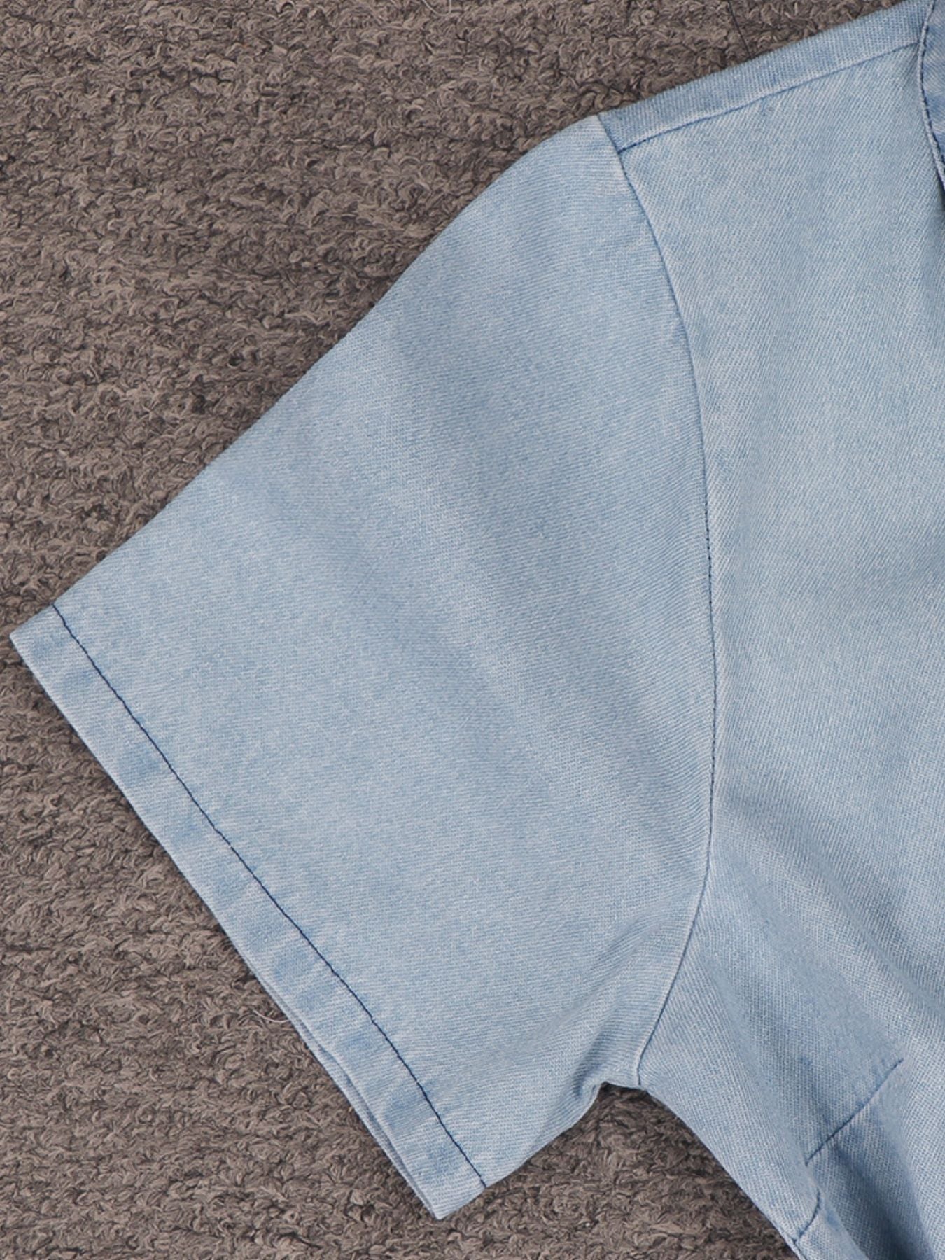 Light blue denim fabric on a brown textured surface