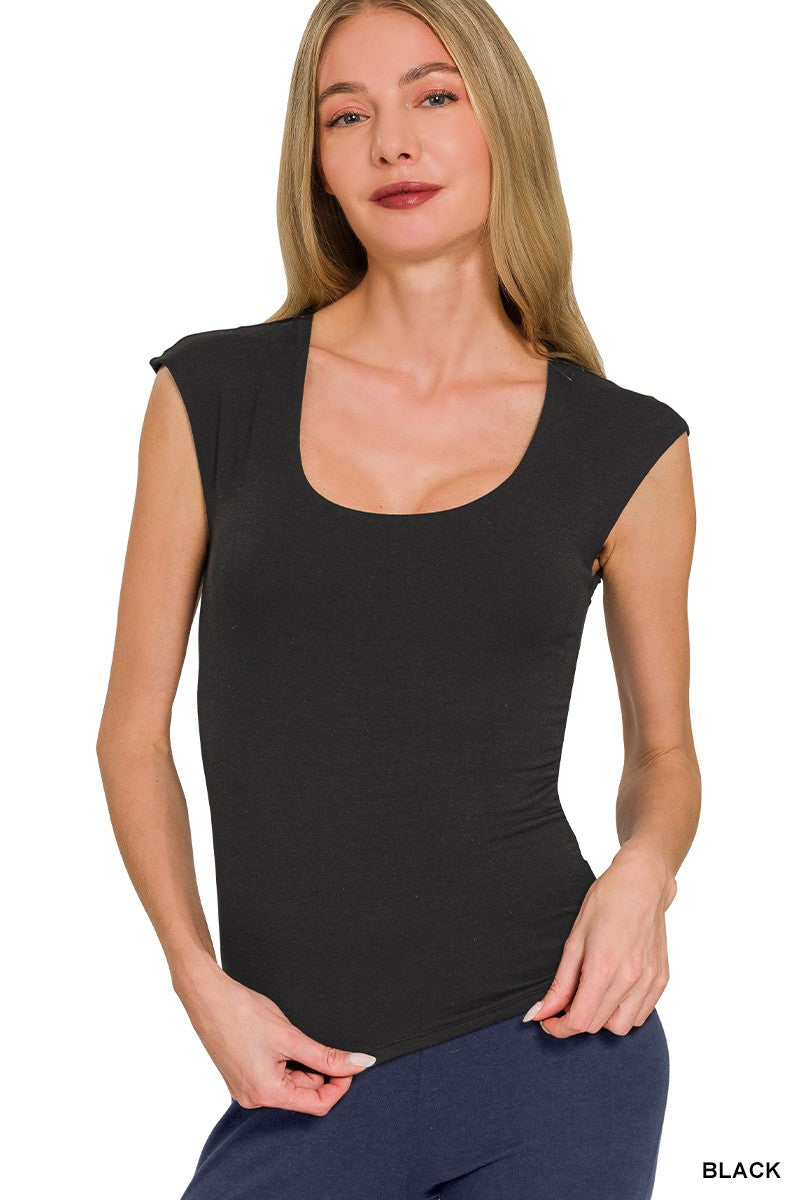 Woman wearing a black sleeveless top on a white background