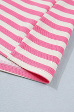 Close-up of a pink and white striped fabric on a light gray background