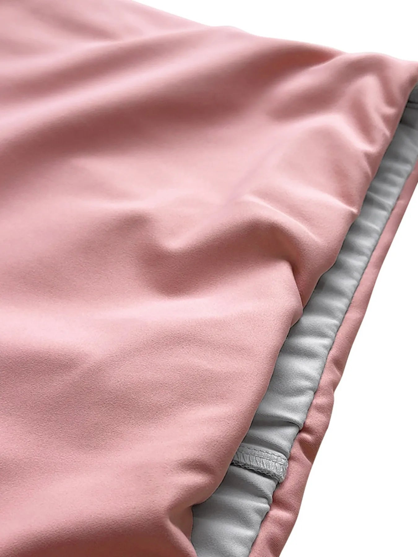 Close-up of pink fabric with gray lining on a white background