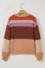 Color-blocked sweater on a hanger against a white background