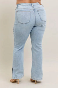 Light blue jeans worn by a person on a beige background