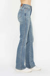 Blue jeans worn by a person on a white background