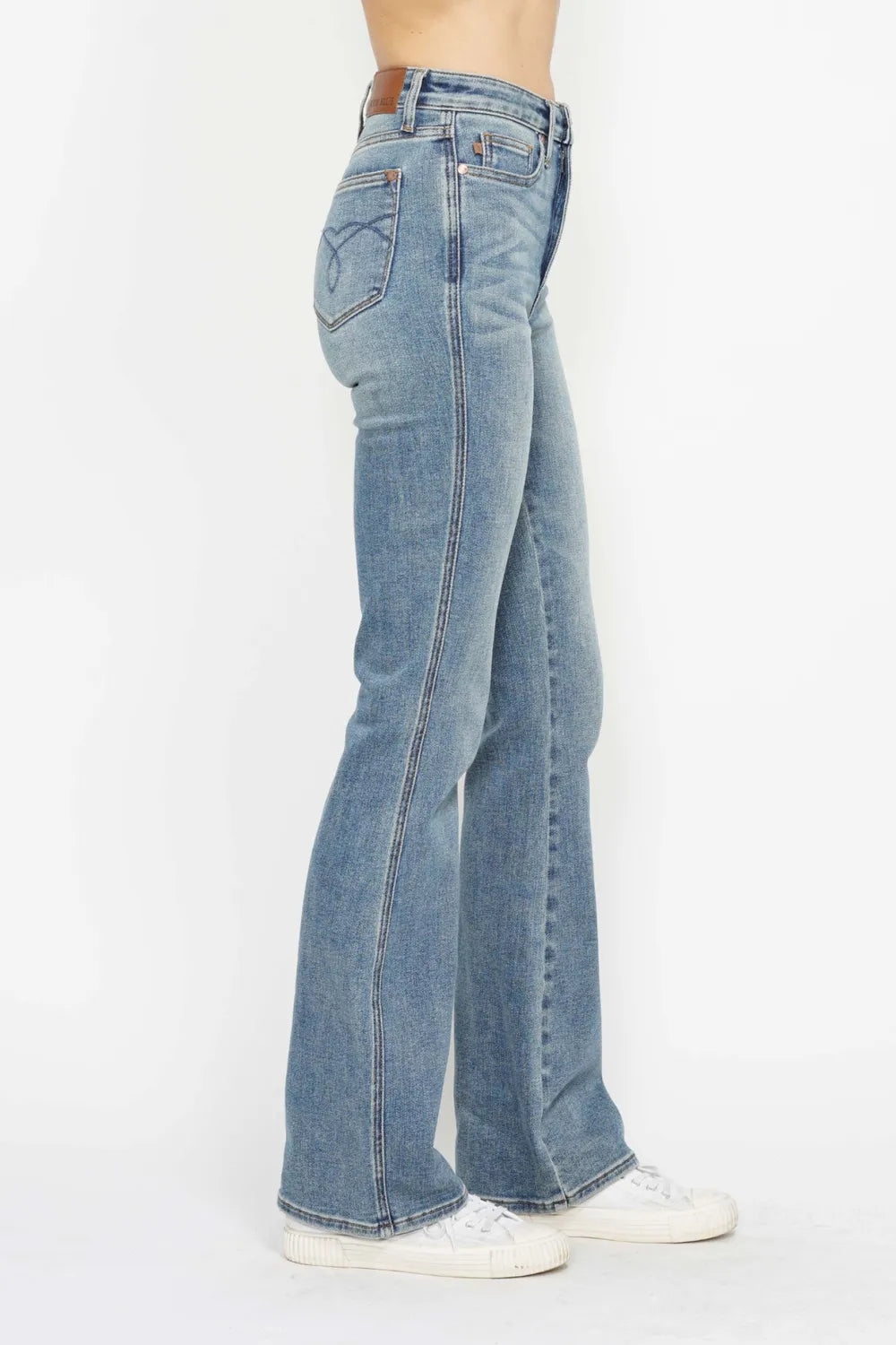 Blue jeans worn by a person on a white background
