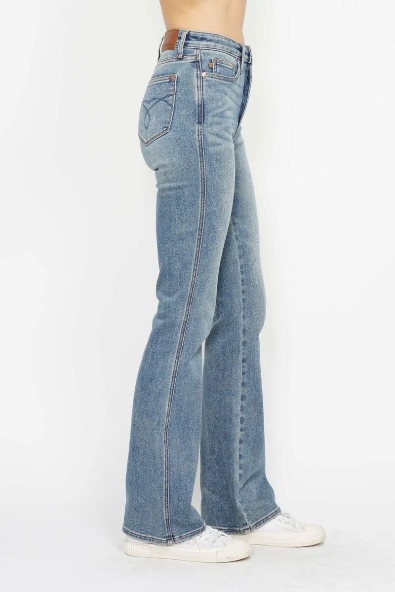 Blue jeans worn by a person on a white background