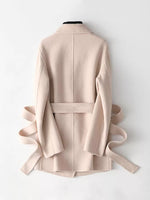 A light beige wrap coat with a matching waist belt, displayed from the back on a white mannequin against a clean white background.
