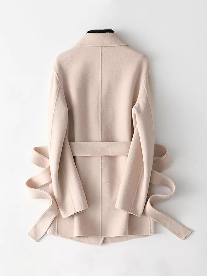 A light beige wrap coat with a matching waist belt, displayed from the back on a white mannequin against a clean white background.