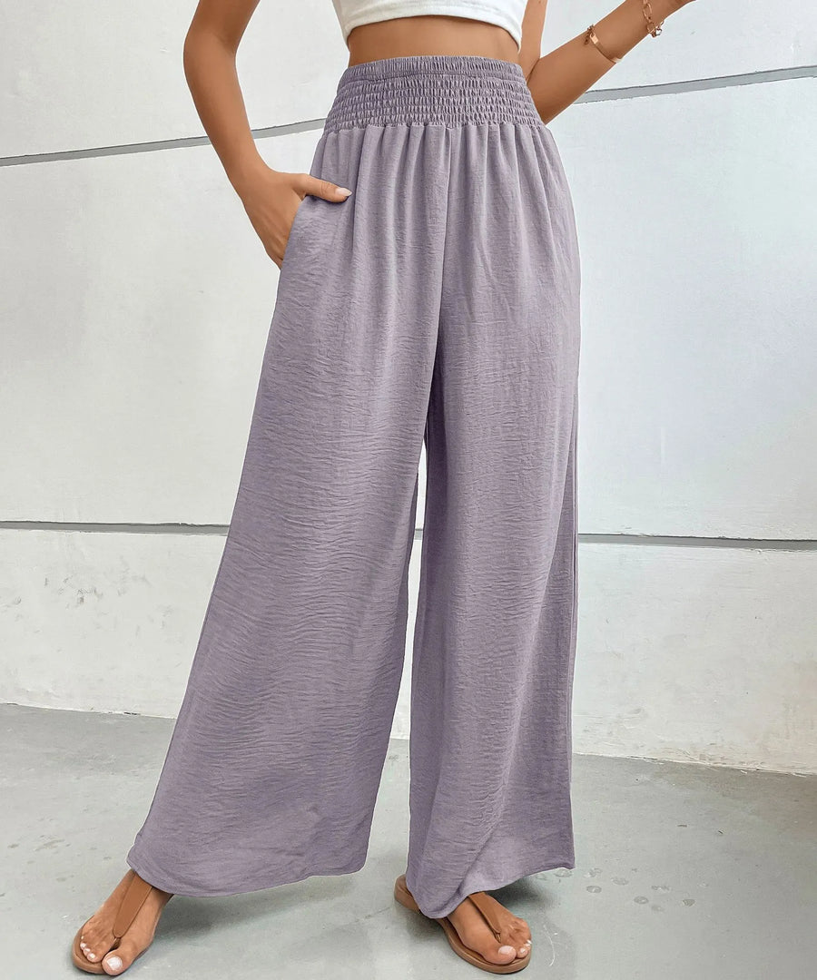 Person wearing light purple wide-leg pants against a plain background
