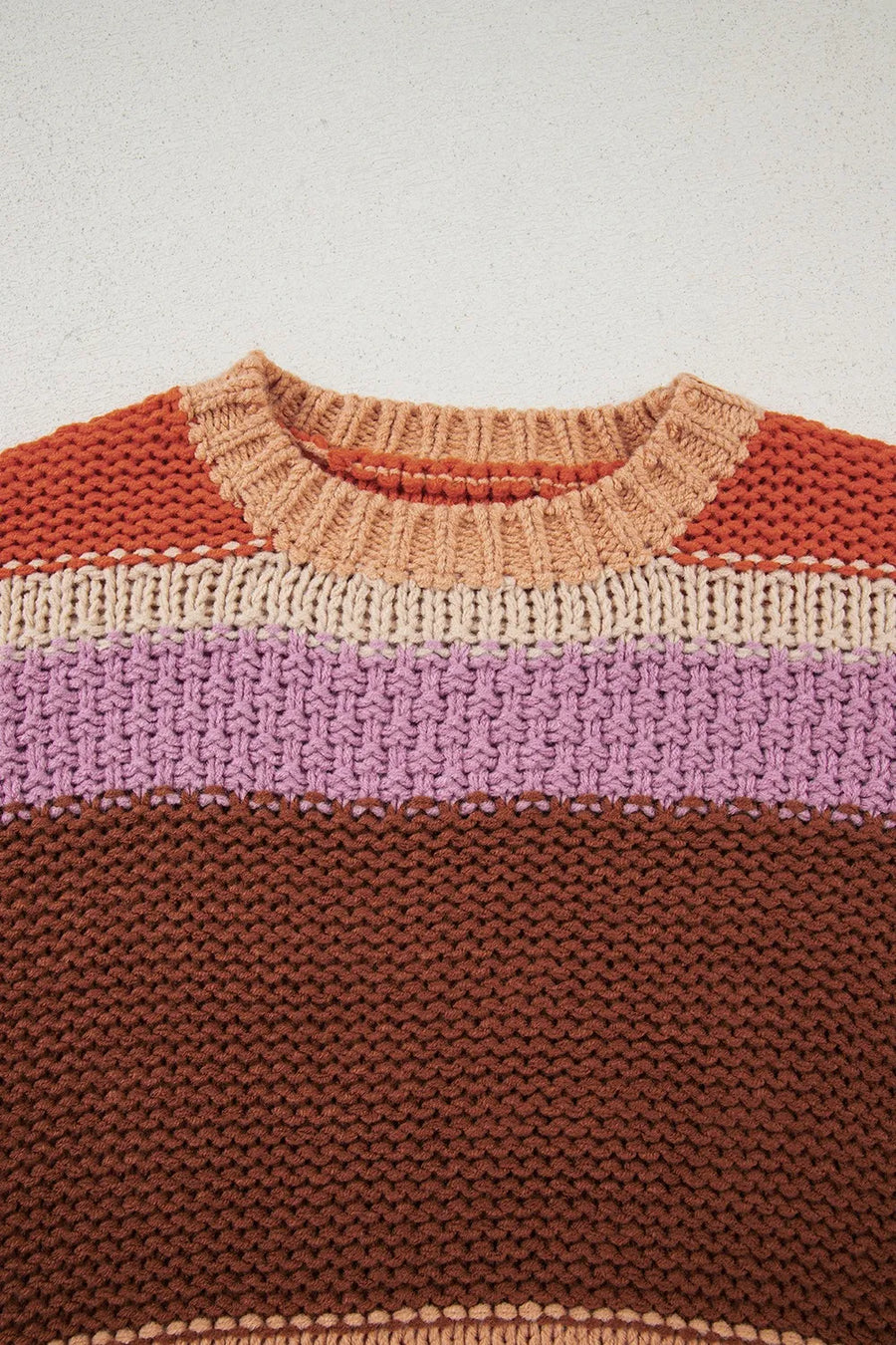 Knitted sweater with color-blocked design on a light background